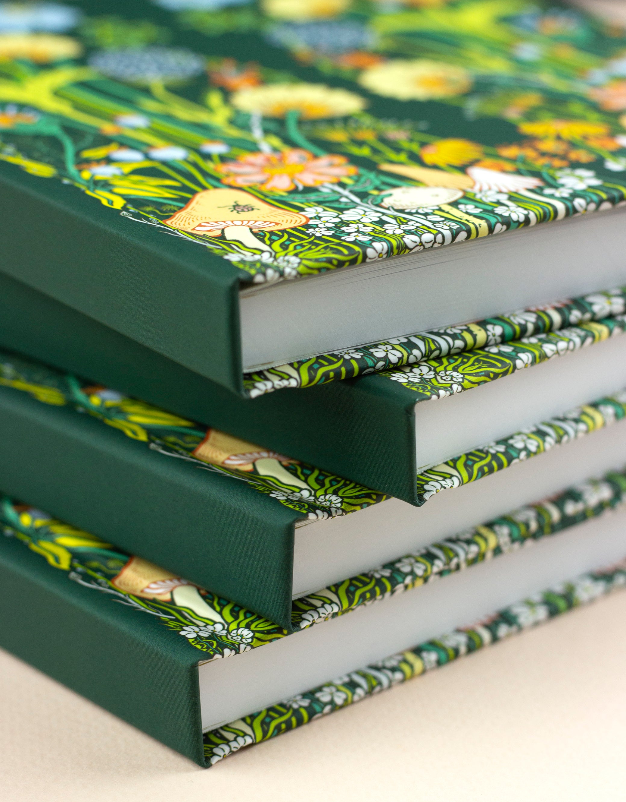 stack of hardcover planners featuring whimsical woodland scene 