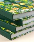 stack of hardcover planners featuring whimsical woodland scene 